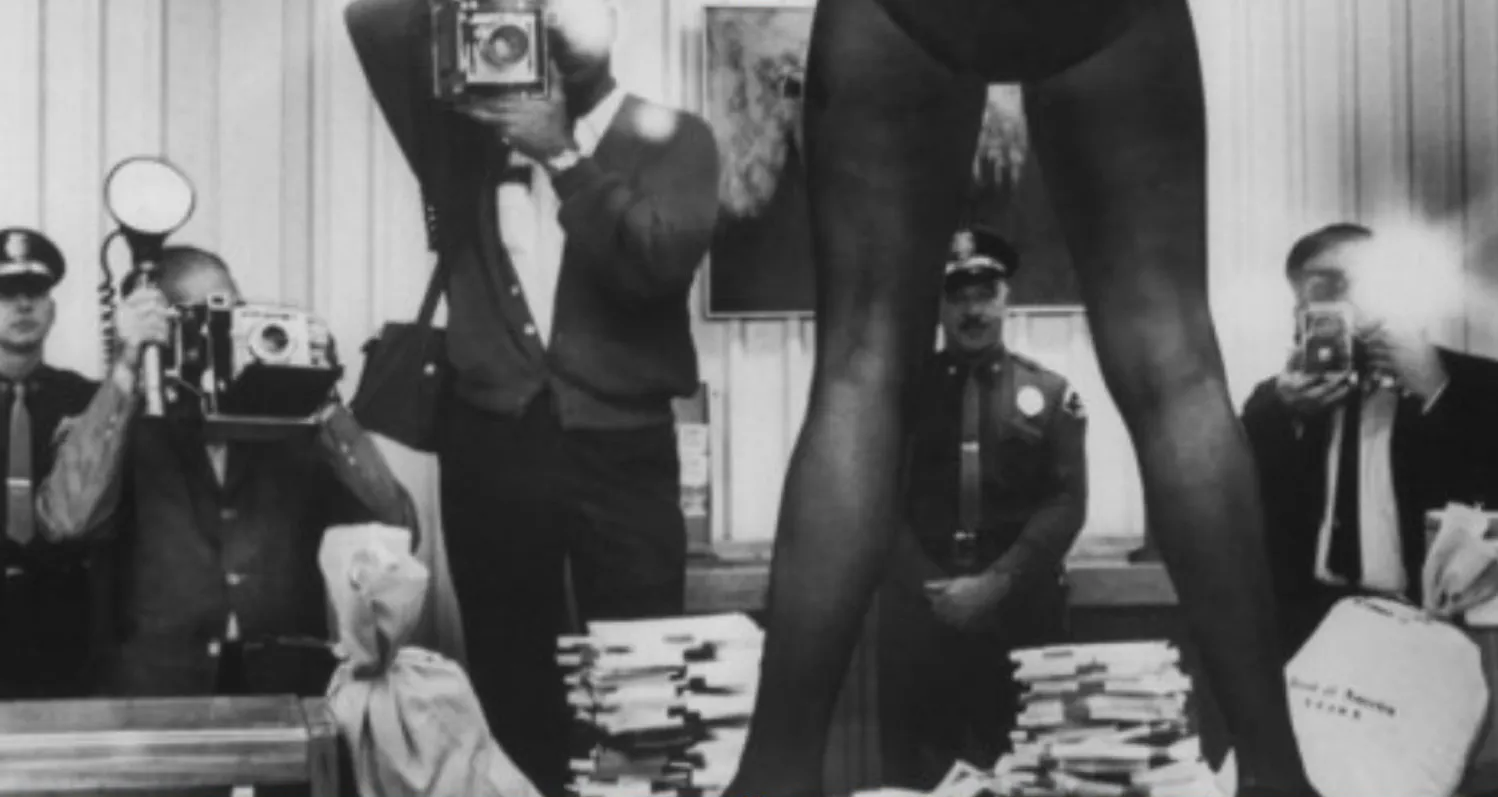 woman standing on table photographed by men