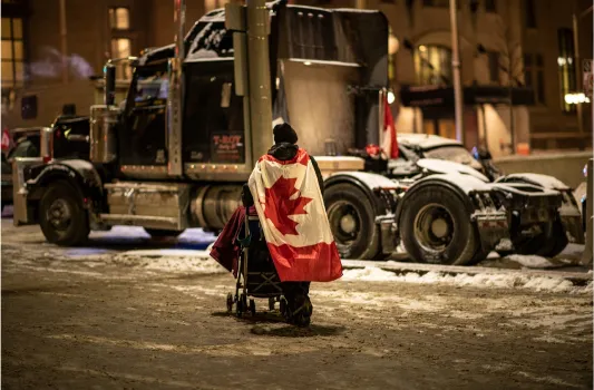 man wearing canada flag in ottawa