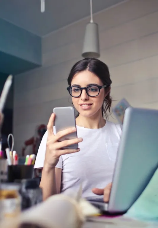 woman in art studio looking at her phone
