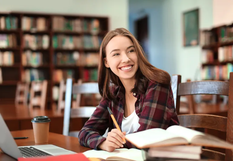 woman sitting in a library studying